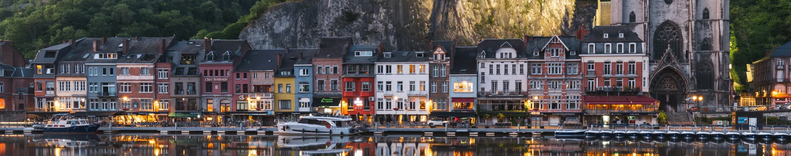 Dinant, Belgium and the Meuse river at dusk. 